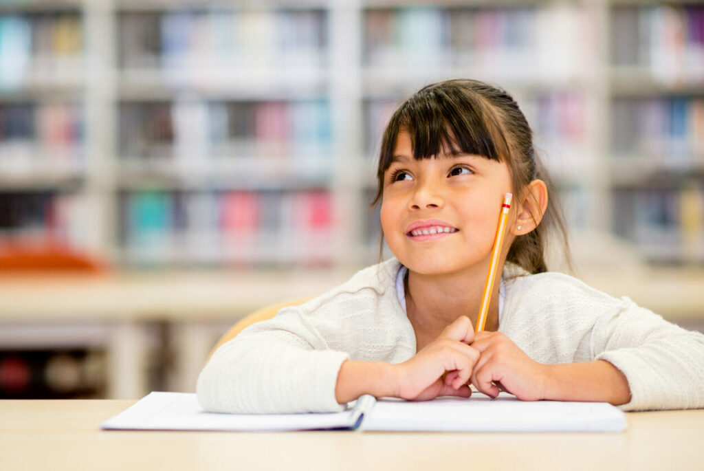 Young female student thinking at the library